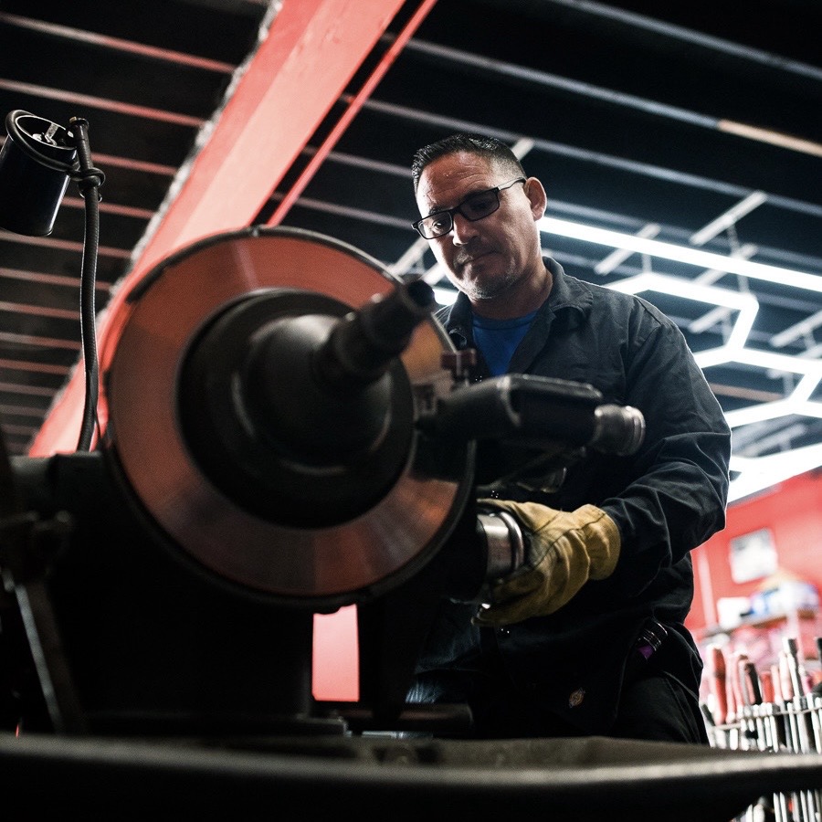 Technician resurfacing a brake rotor on the lathe