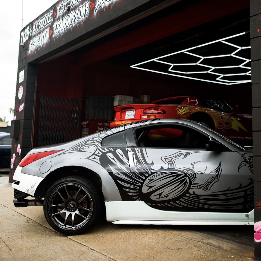 Nissan 350Z parked at the shop bay under hex lighting